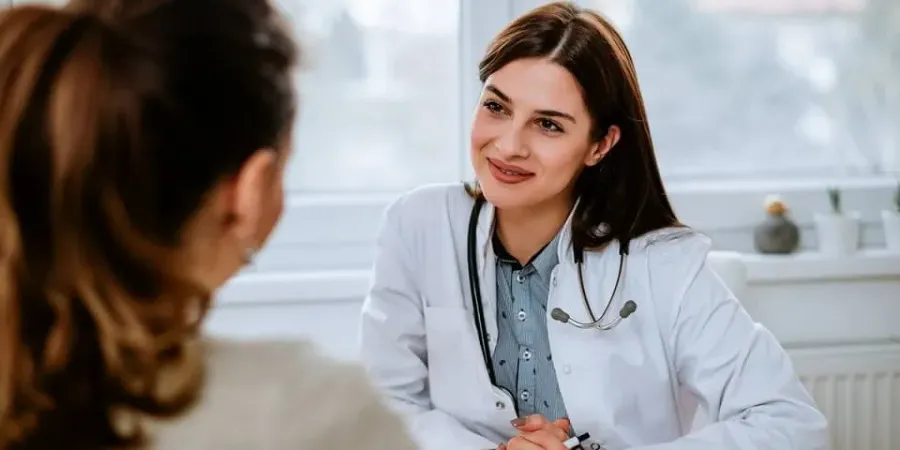 Family nurse practitioner smiling with patient during appointment