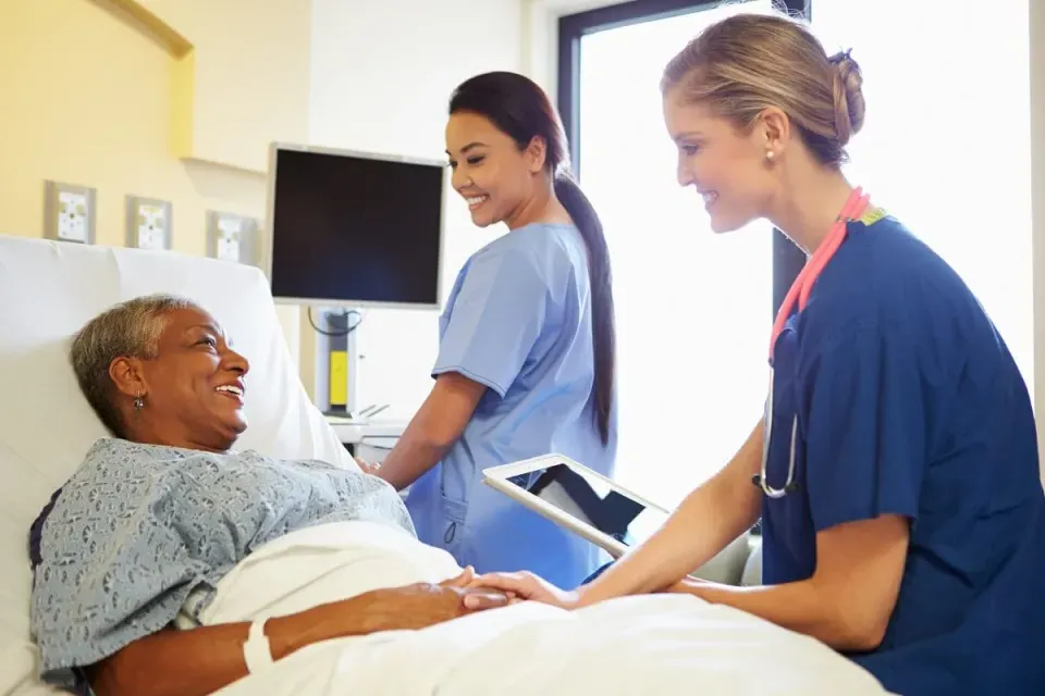 CVICU Cardiac Nurse Speaking with Patient in Hospital Bed